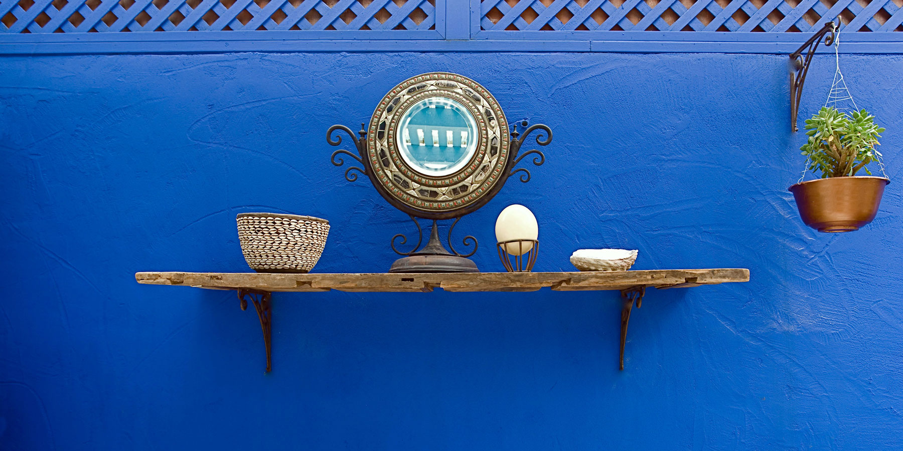 Blue wall, and shelf with African accents