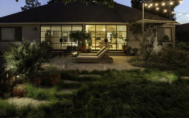 View at evening: Pathway through grass and patio